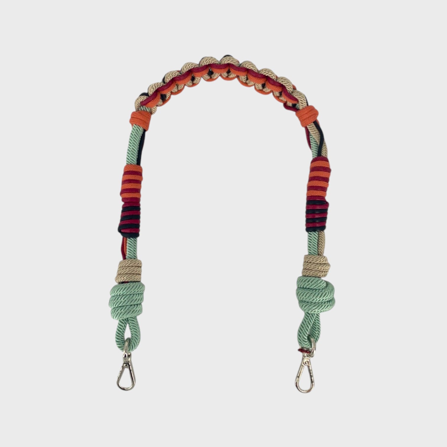 Multicolored braided macramé bag strap in soft light blue, soft pink, and burgundy shown on a light gray background.