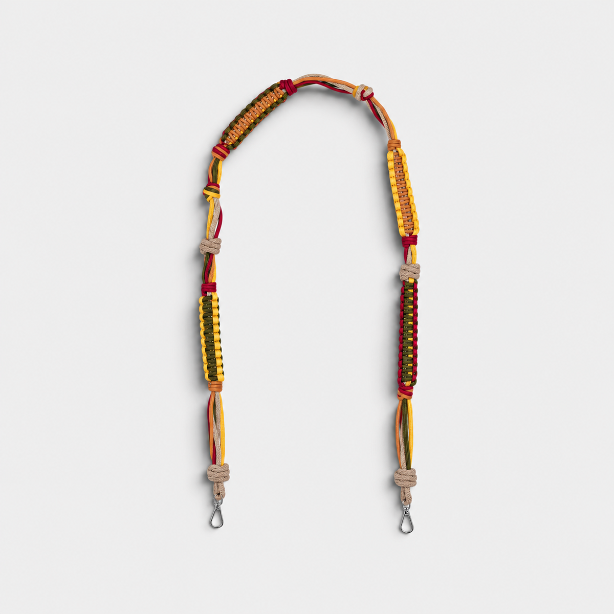 A macramé yellow, green, burgundy ans beige bag strap. 