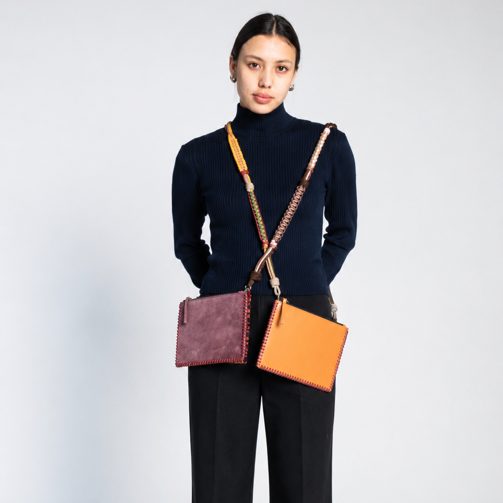 A woman carrying crossbody two rectangular bags. 
