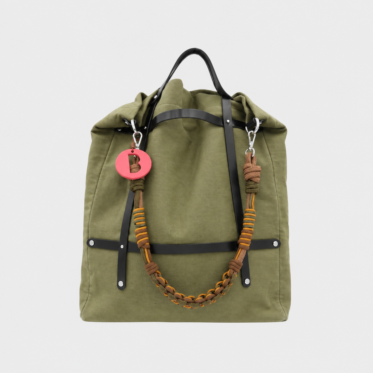 Green optimiste tote bag with braided brown macrame shoulder strap on a white background.