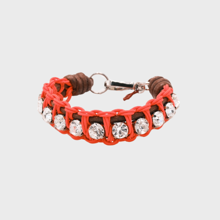 A braided macramé bracelet featuring brown and orange cords with small white beads.