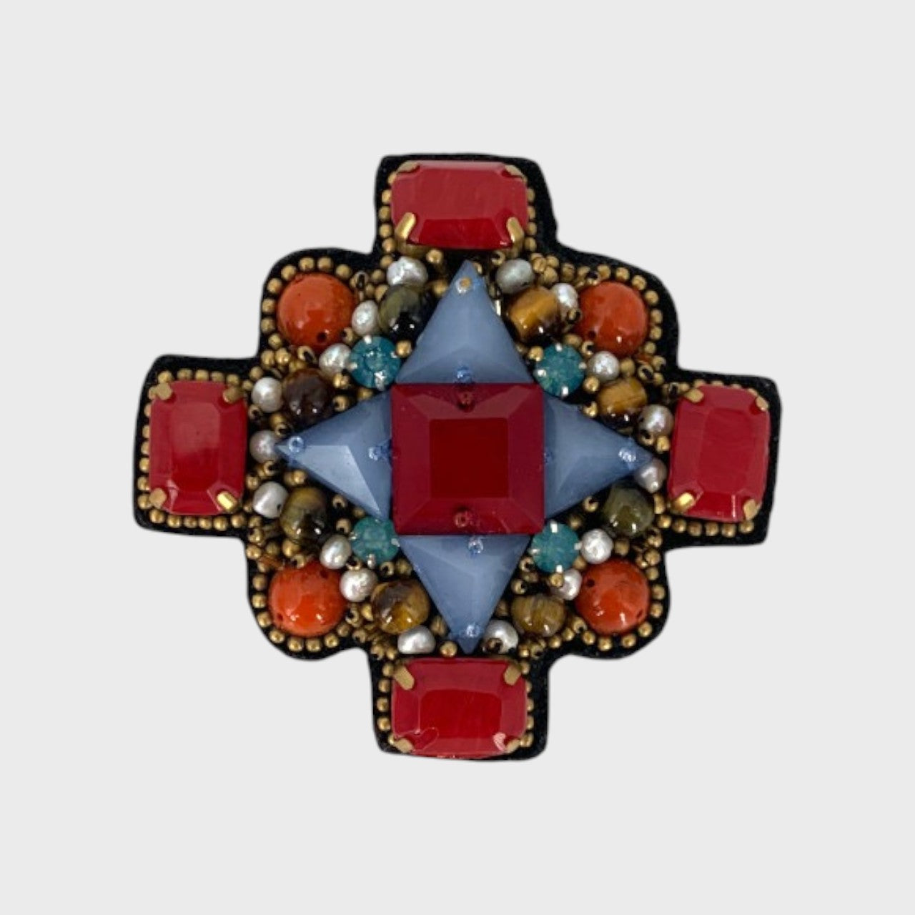 An embroidered brooch representing an orthodox cross with red, blue and orange stones. 