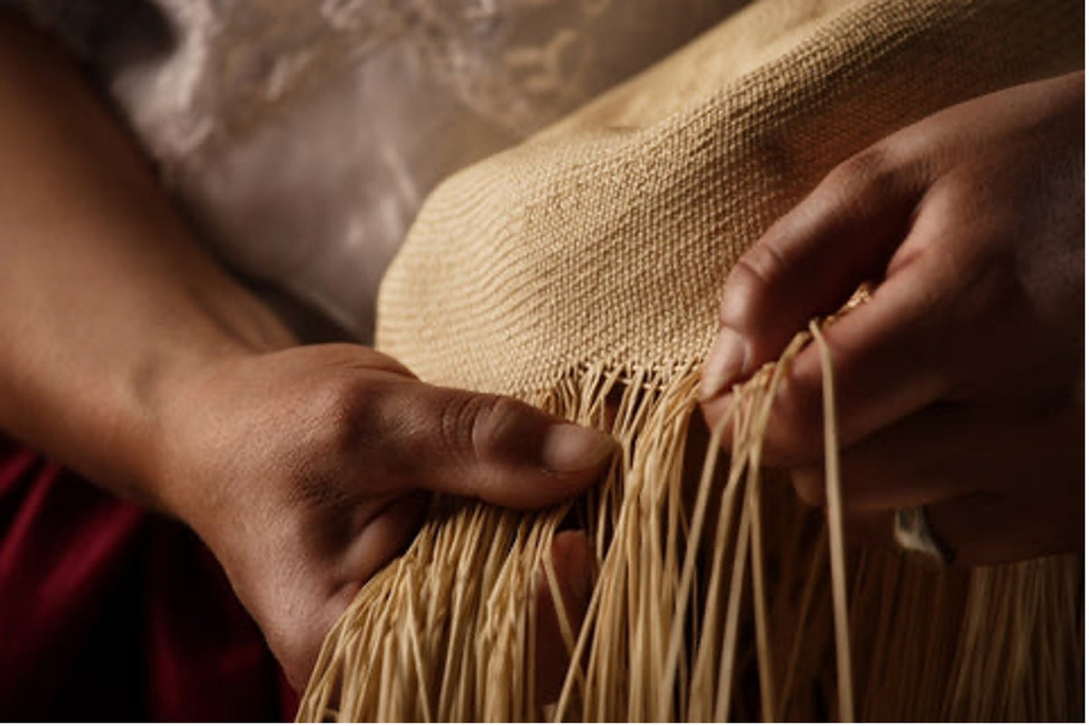 A picture of a person manufacturing a panama hat. 