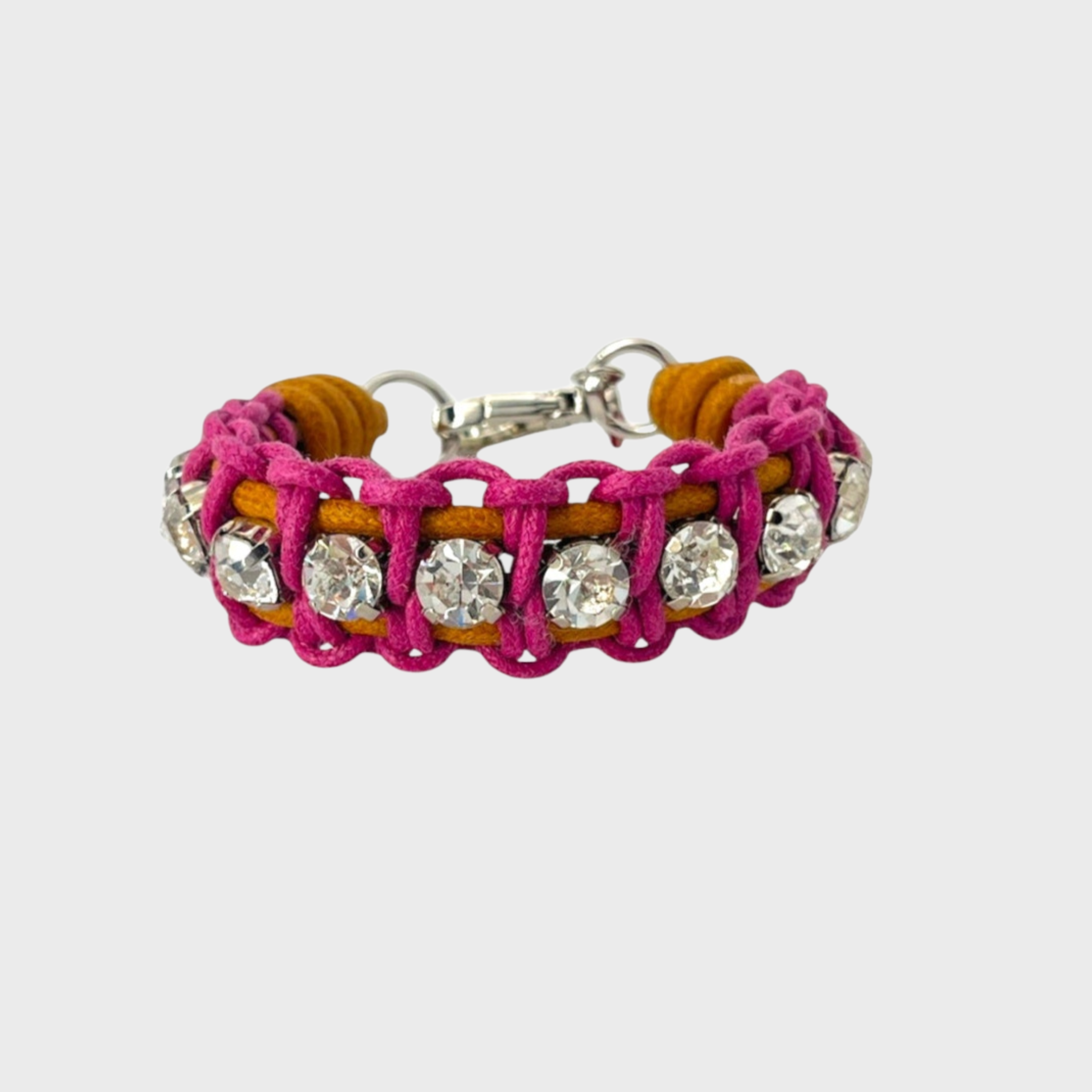 A braided macramé bracelet featuring pink and mustard cords with small white beads.