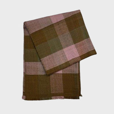 Folded checkered cashmere shawl or scarf with brown and pink plaid pattern on a light gray background