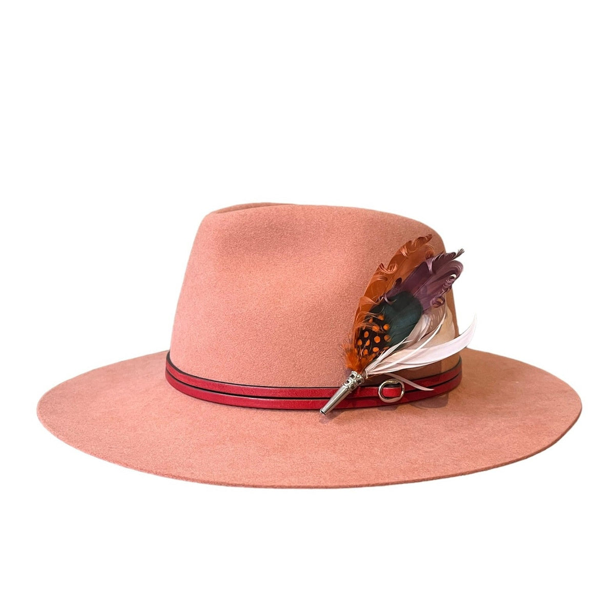 A pink wool hat with a leather band and a decorative feather brooch attached to the brim.