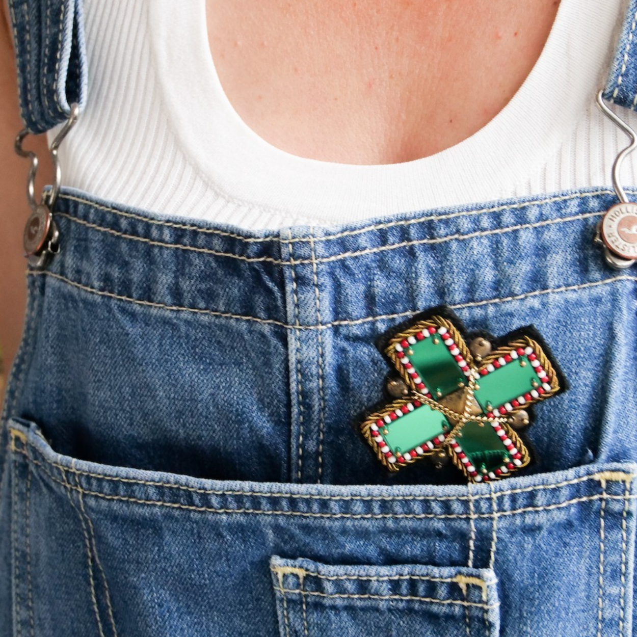 A model wearing the green plus brooch. 