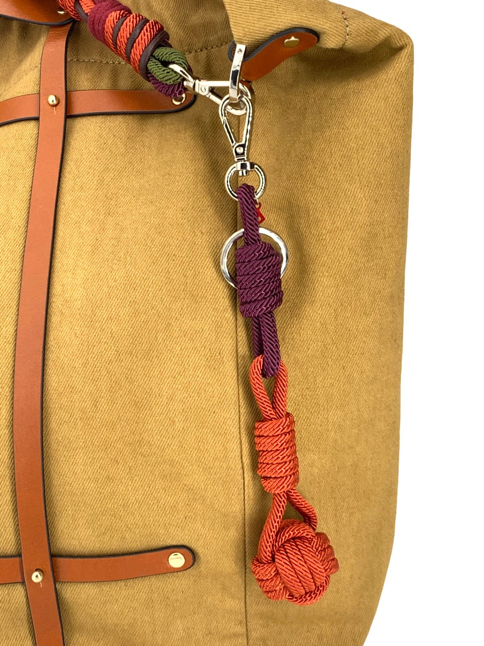 A purple and orange sailor ball on a yellow bag. 