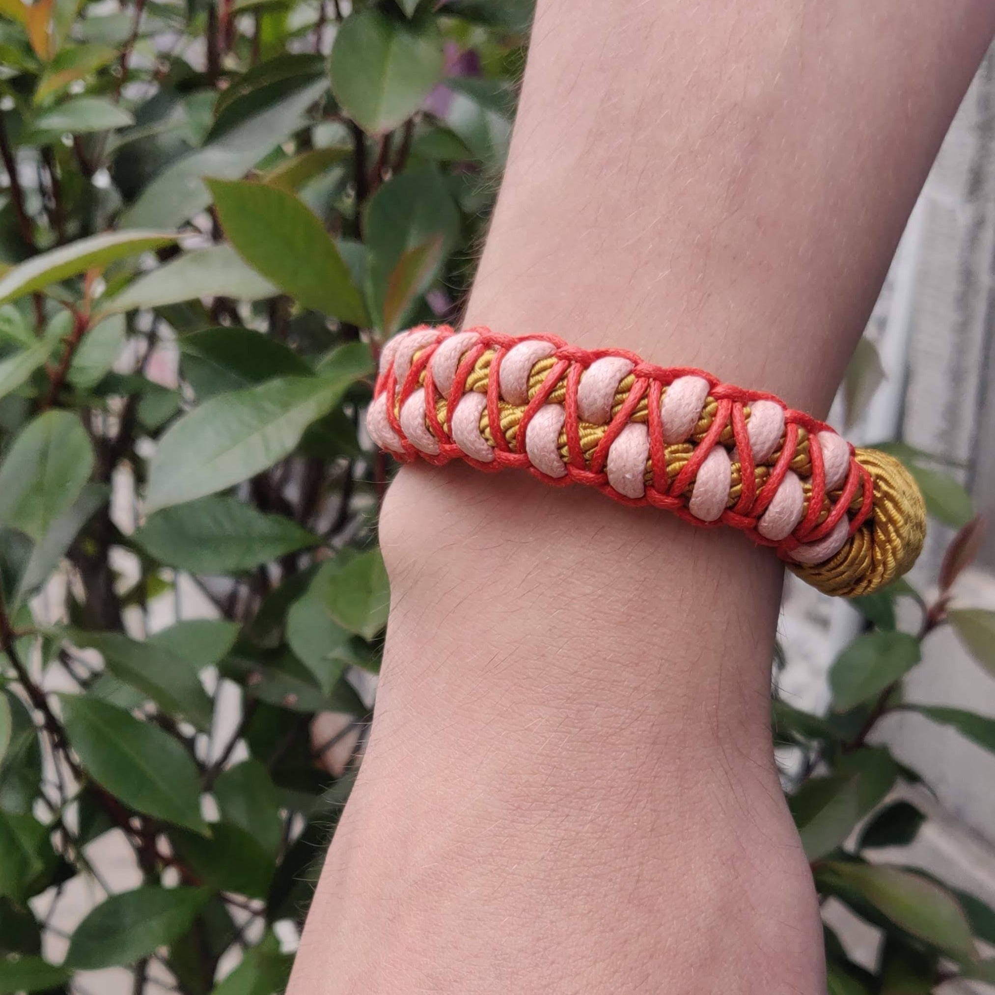 The red, light pink and yellow Emil Bracelet worn by a model