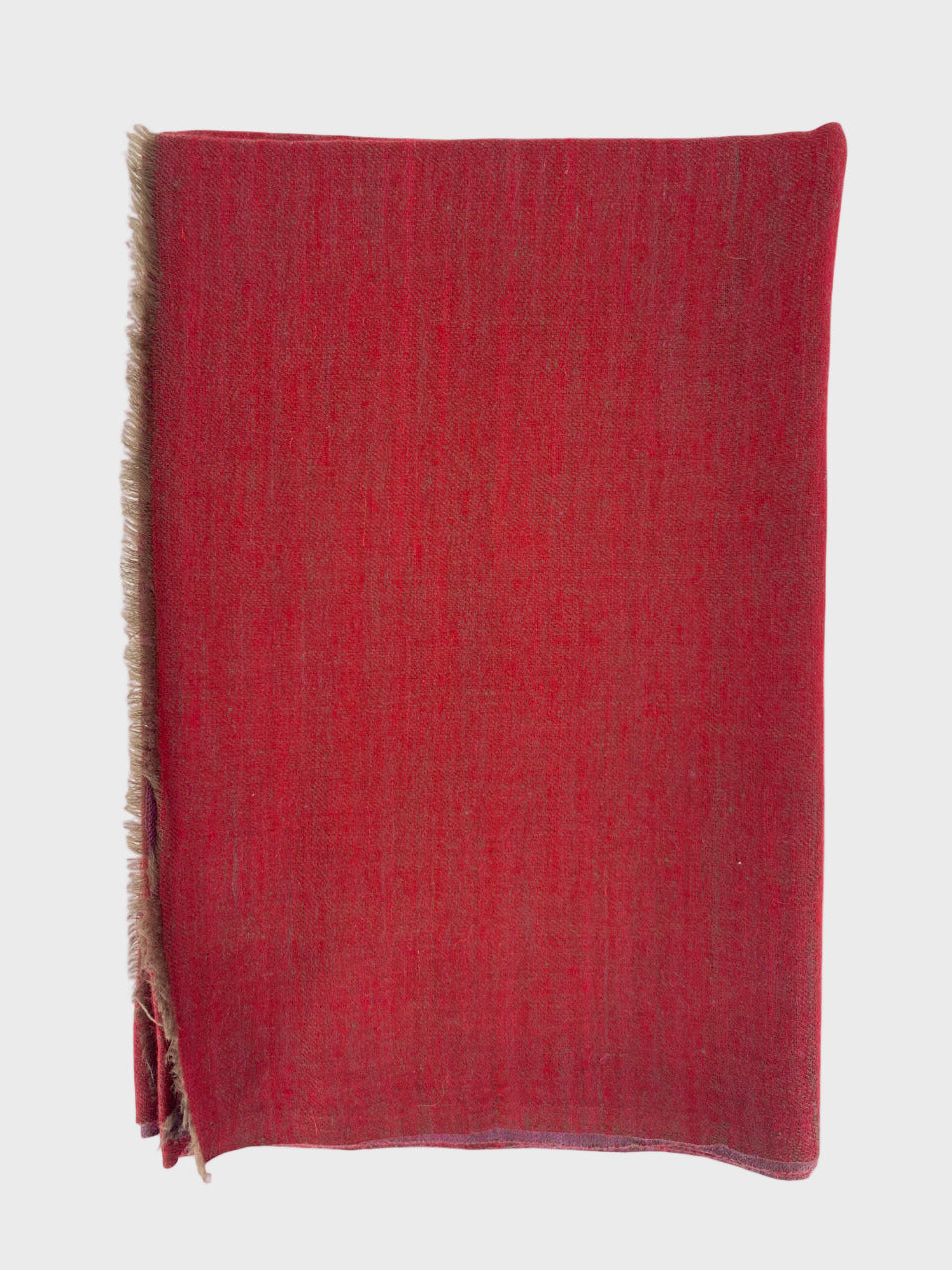 Red cashmere shawl with frayed edges on a white background