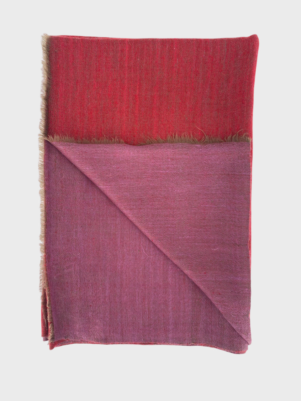 Folded cashmere shawl with red and pink gradient on a white background