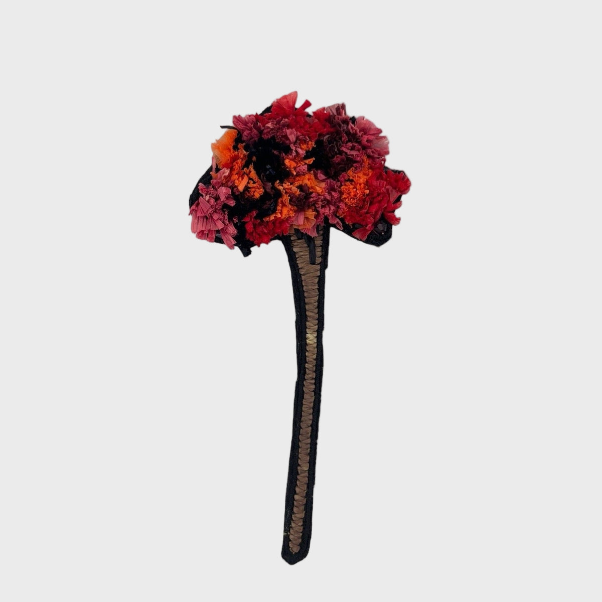Colorful flower-shaped embroidered brooch on a white background