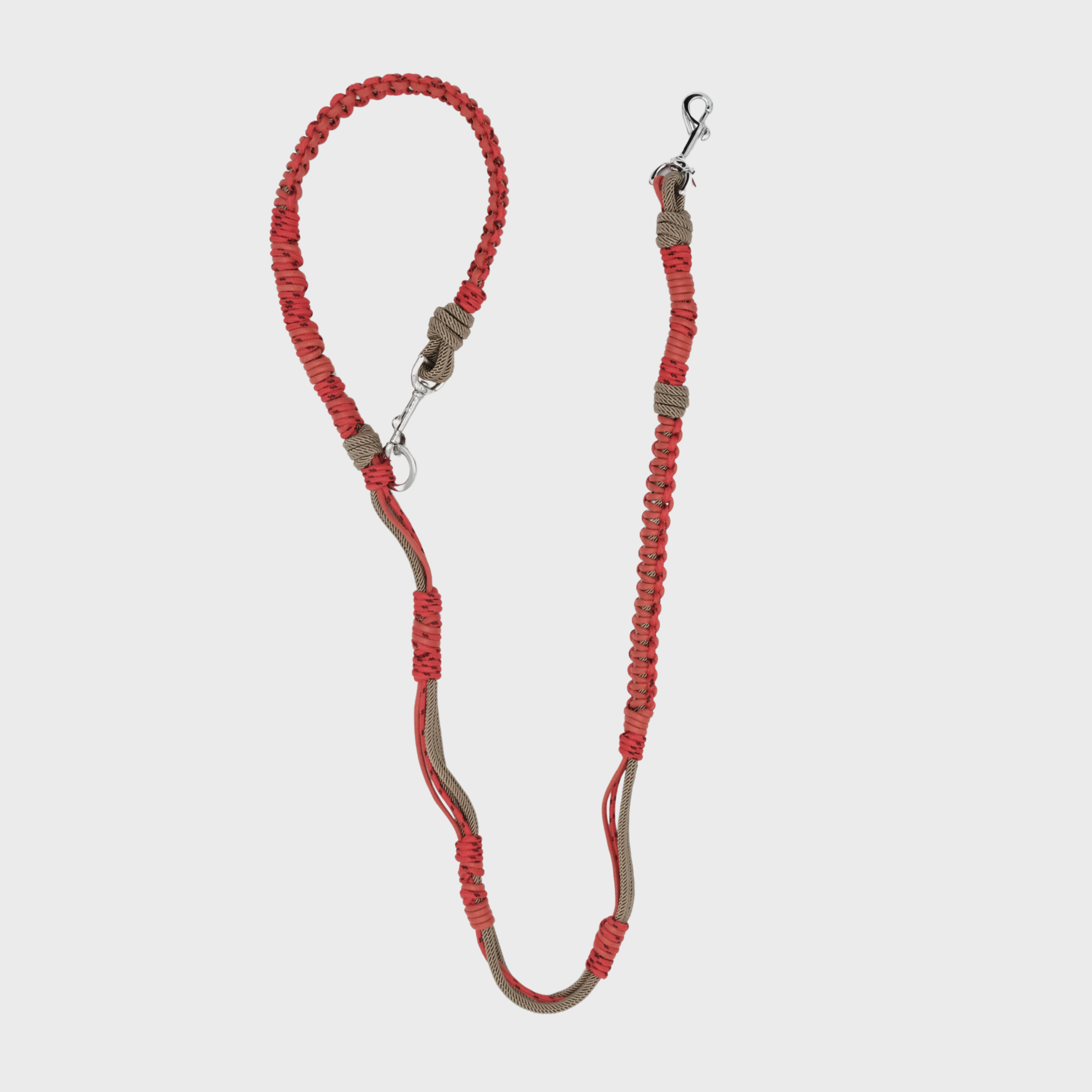 A braided macramé dog leash with red and light brown woven sections, and a silver metal hardware