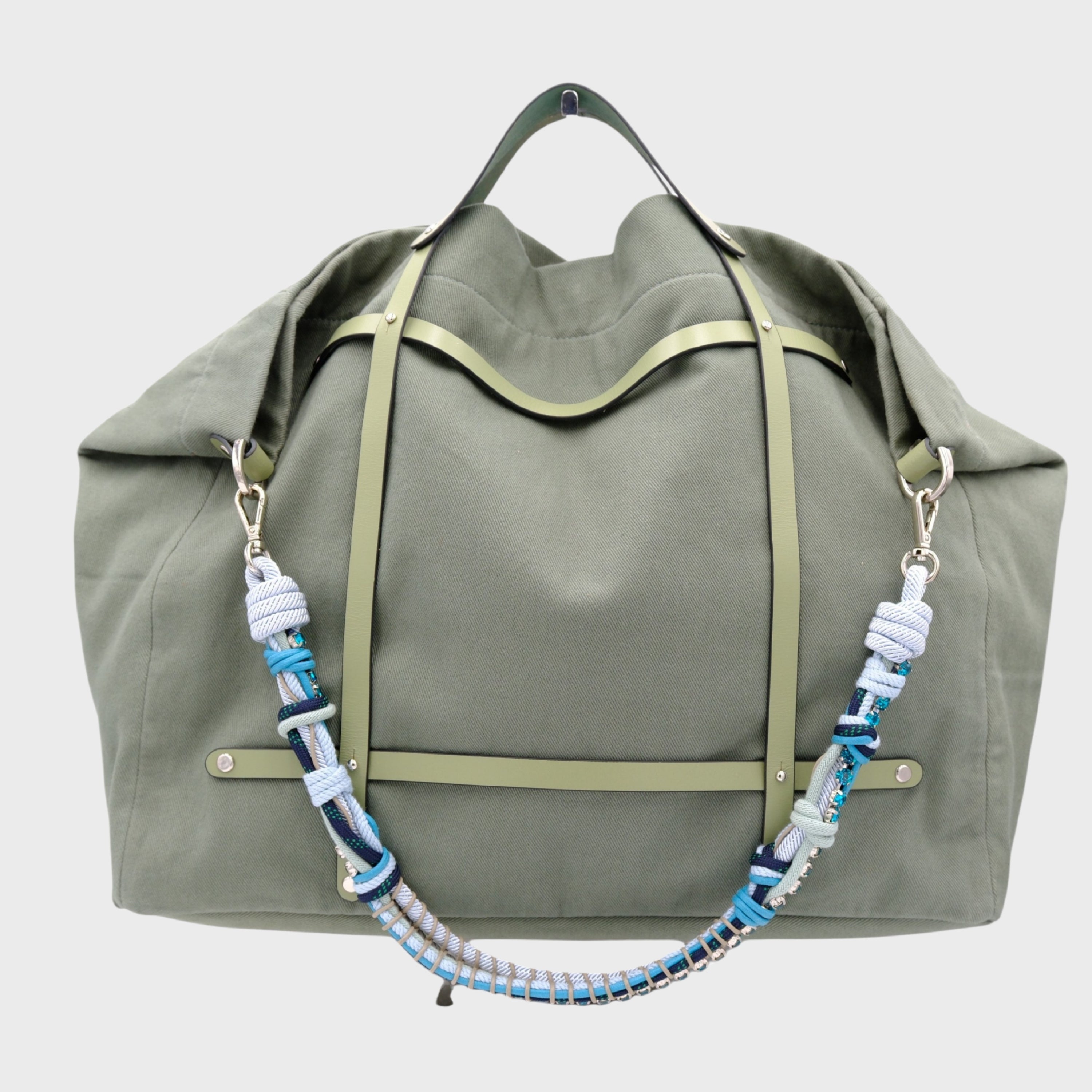 Green weekend or duffel bag in canvas and green leather harness, paired with the added colorful blue macramé and beaded shoulder strap. 