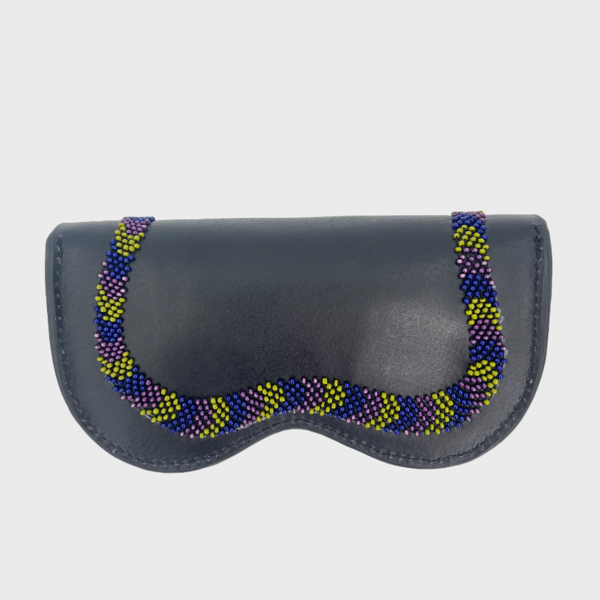 The back of the dark blue leather snake glasses case, with the end of the pink, green and blue wavy embroidered snake.