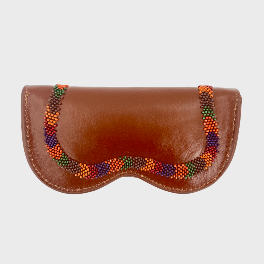 The back of a brown leather eyeglasses case with a decorative beaded border featuring orange, green, red, and purple beads, shown against a light gray background.