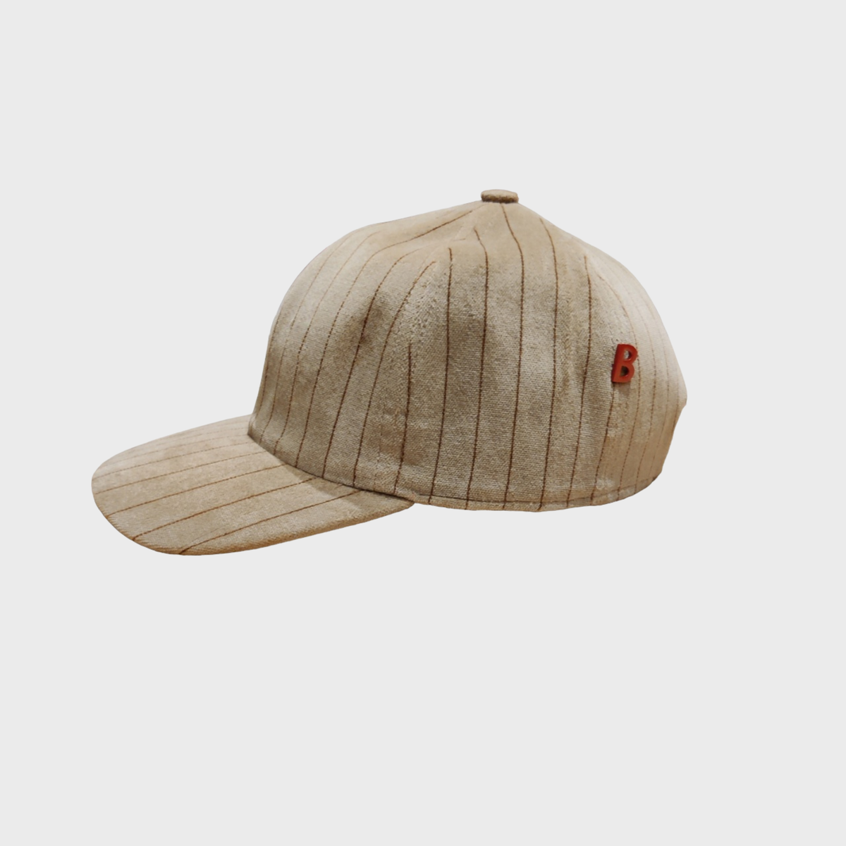 A light brown baseball cap in velvet with brown lines. 