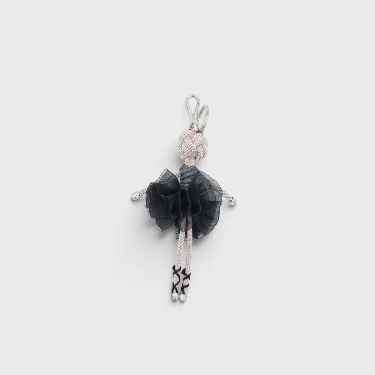 Decorative keychain with a a ballerina wearing a black tutu on a light gray background