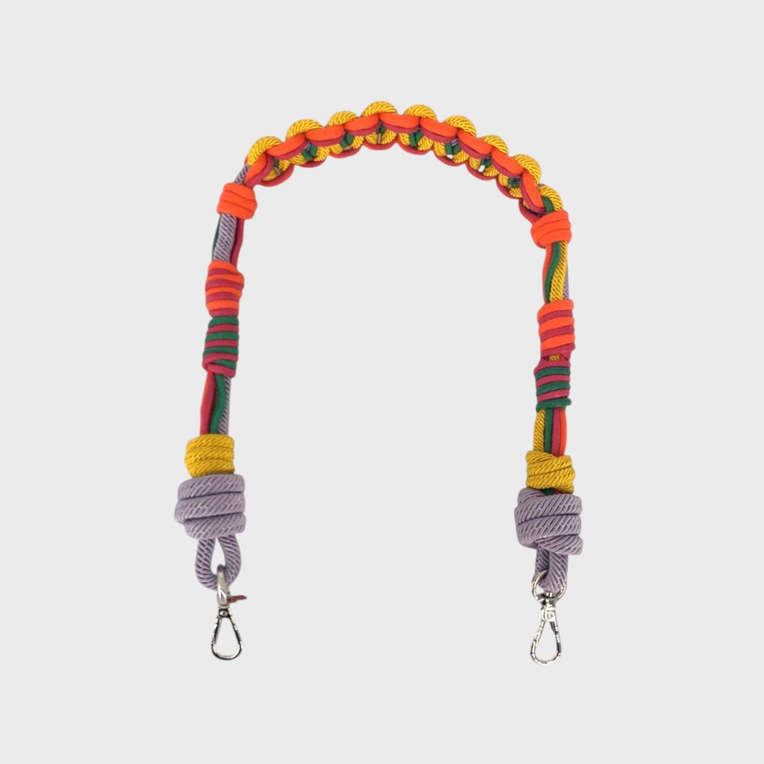 Multicolored braided macramé bag strap in yellow, lilac, orange, and green shown on a light gray background.