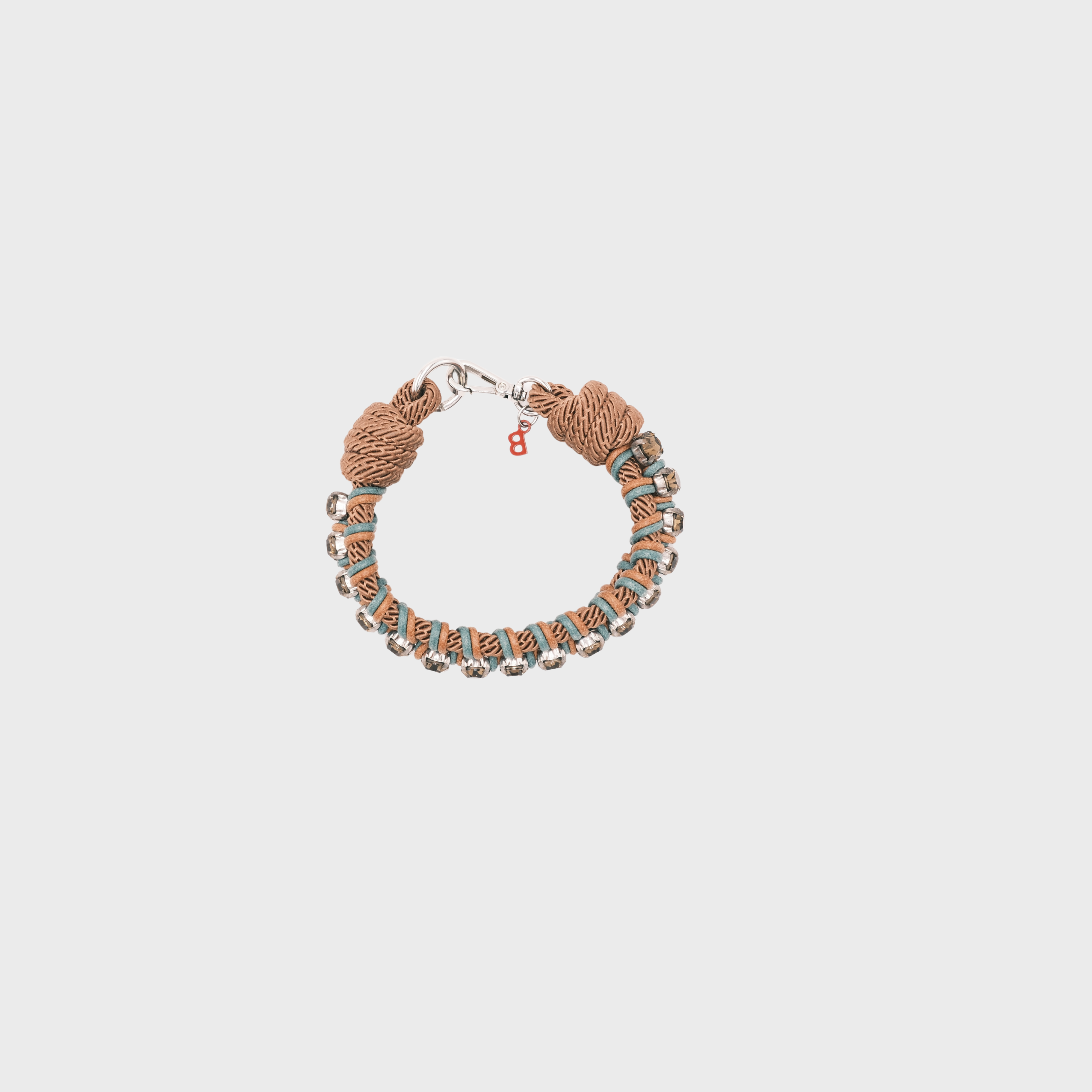 A handmade macramé woven collar featuring a mix of brown, and green threads, accented with smal beads and a silver clasp.