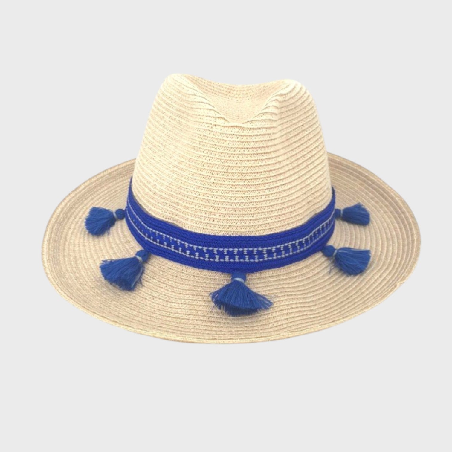A white raffia hat with a blue cotton hatband with tassels facing the camera. 