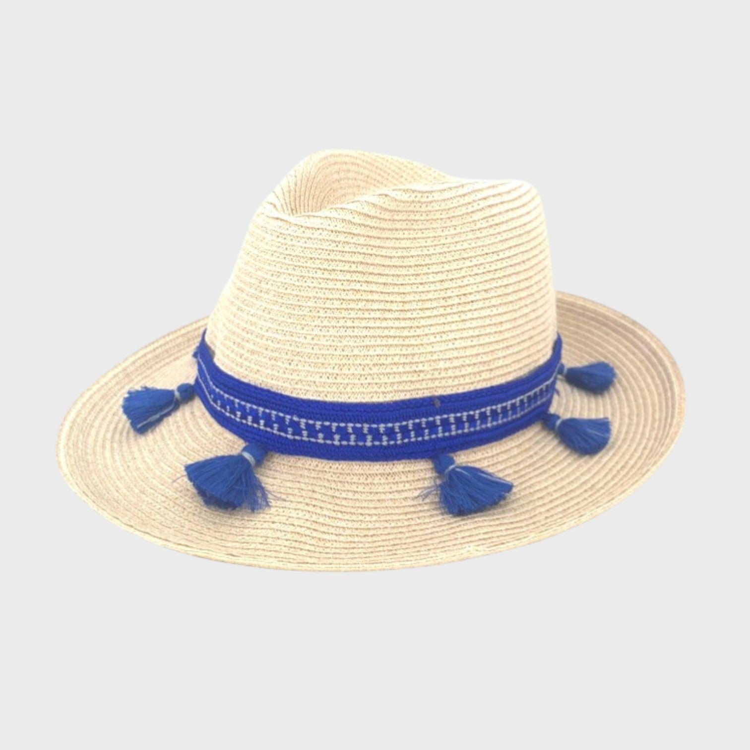 A white raffia hat with a blue cotton band around it with tassels. 