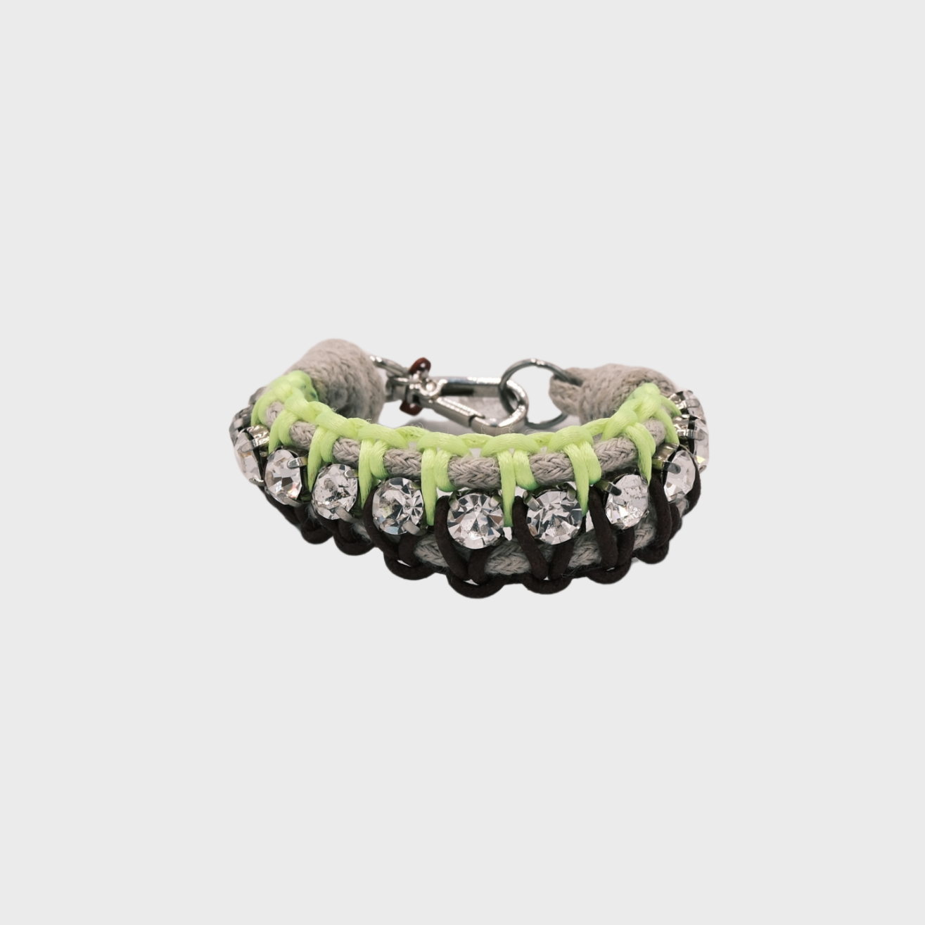 A braided macramé bracelet featuring brown and neon yellow and beige cords with small white beads.