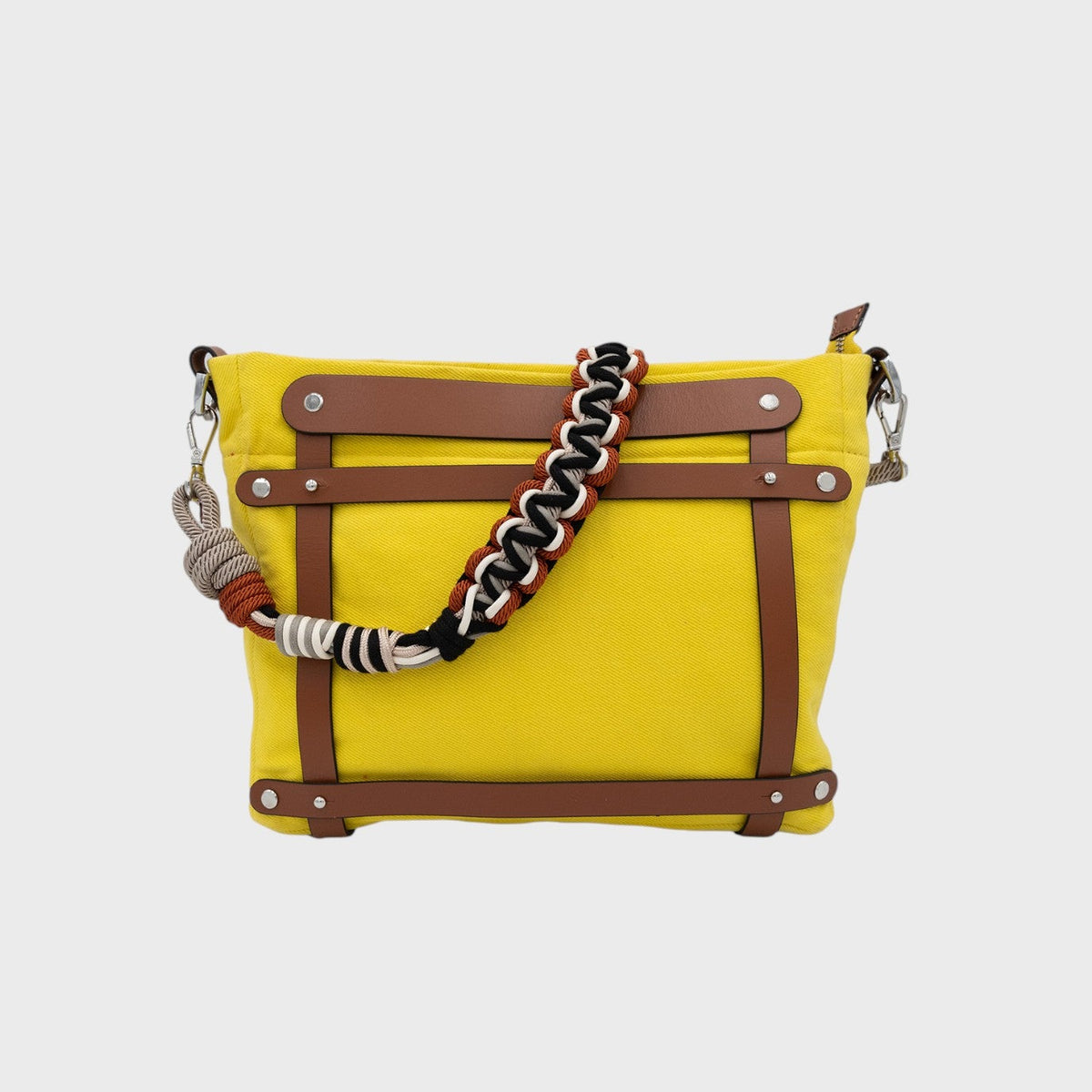 A yellow canvas mini tote bag with brown leather and a black grey and orange beaded strap. 