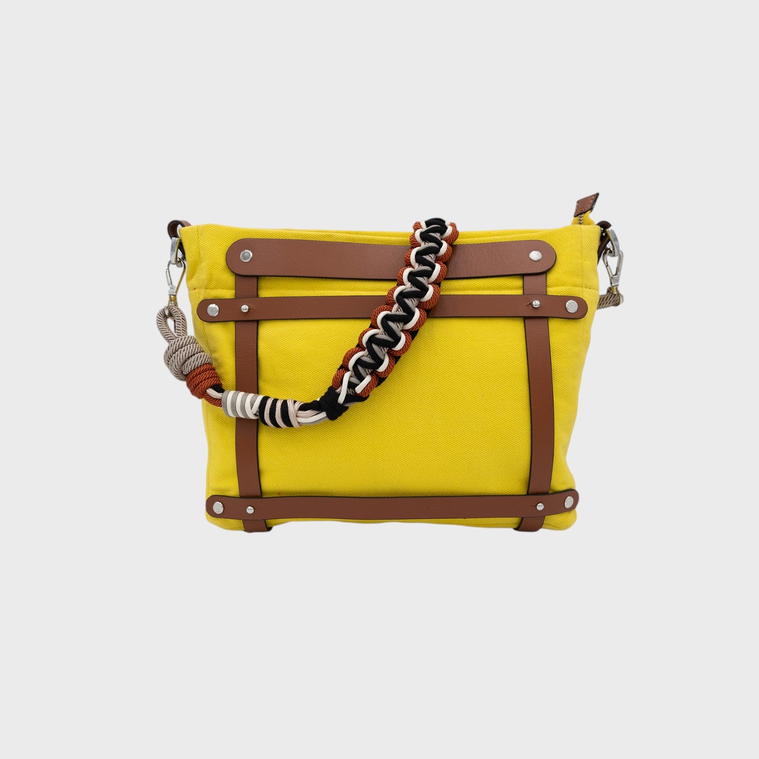 A yellow canvas mini tote bag with brown leather and a black grey and orange beaded strap. 