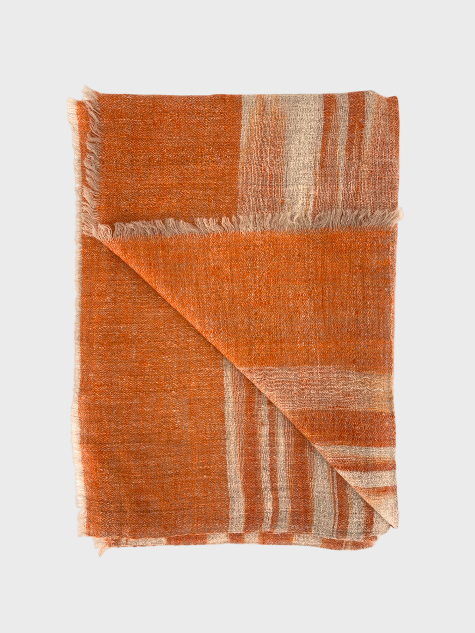 Orange and beige shawl on a white background