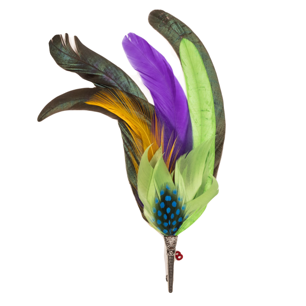 A feather brooch with green, yellow, purple and black feathers. 