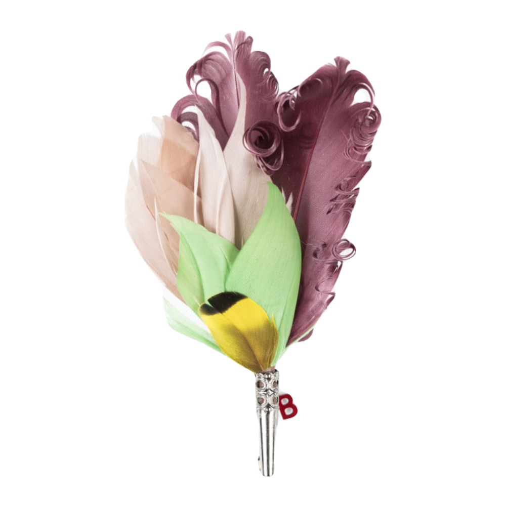 A feather brooch with curled purple feathers and green, beige and yellow feathers. 