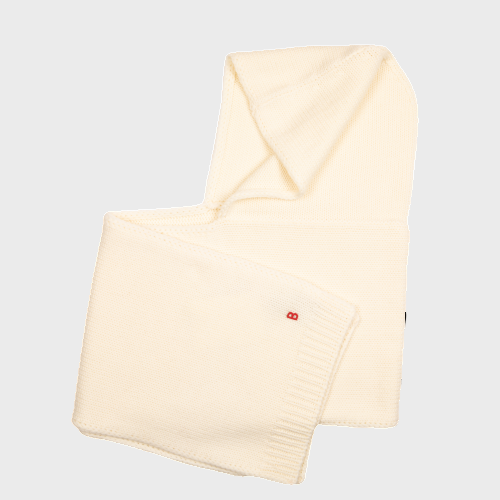 white wool hat scarf with a small red logo pinned on it on a light gray background